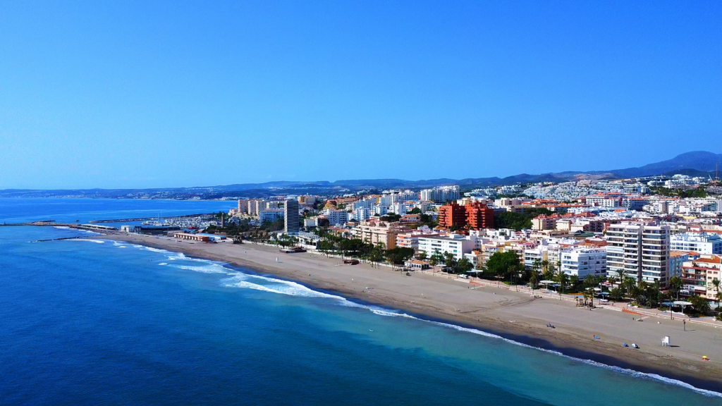 Aerial view of Estepona’s coastline, sandy beach and waterfront apartment buildings.